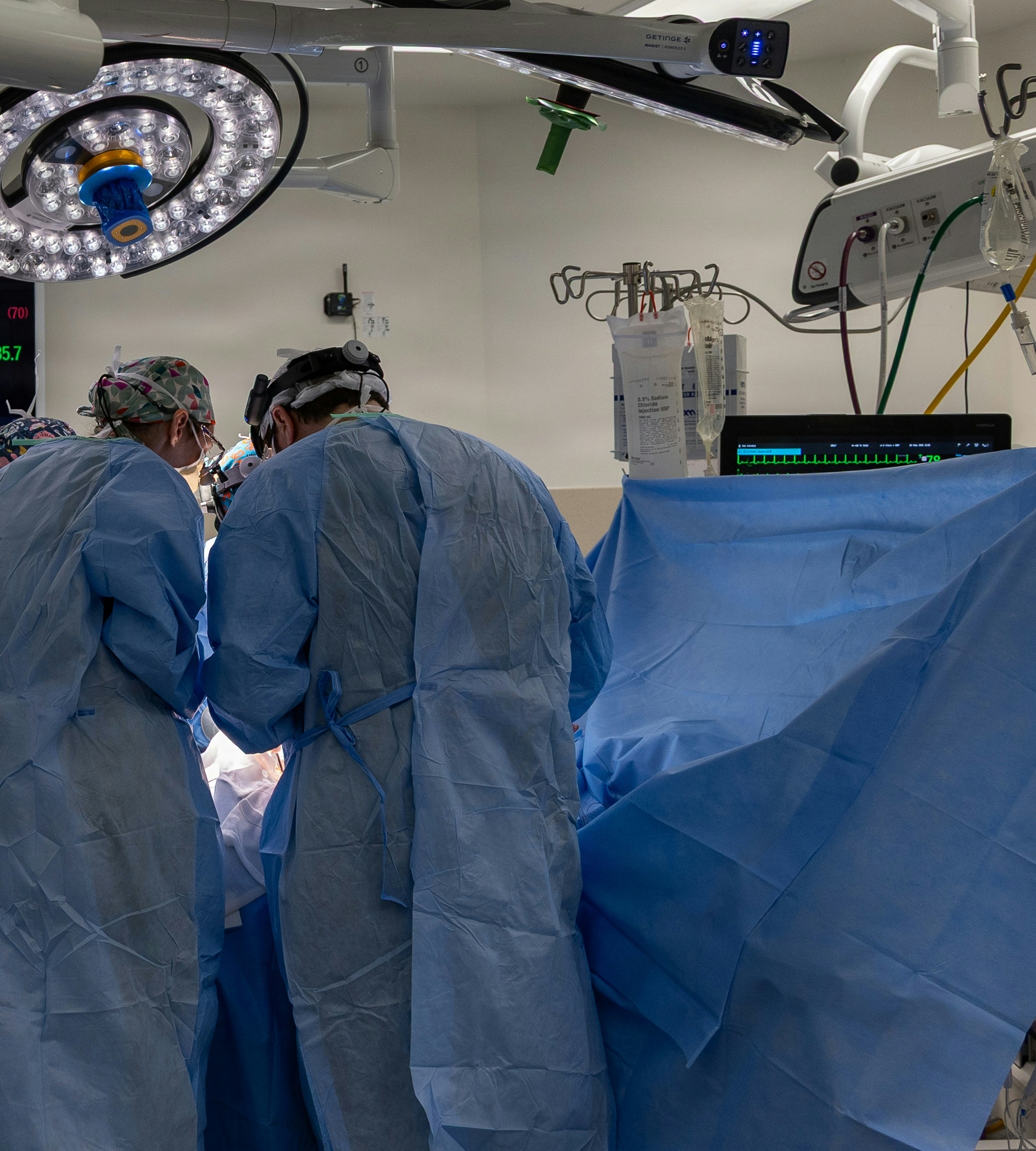 Surgical team performing live surgery in an operating theater